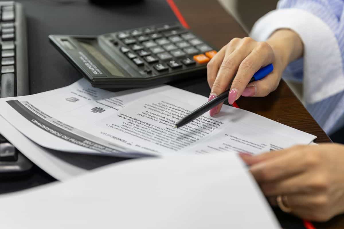 Reviewing water-damage scope and costs with paperwork at a desk