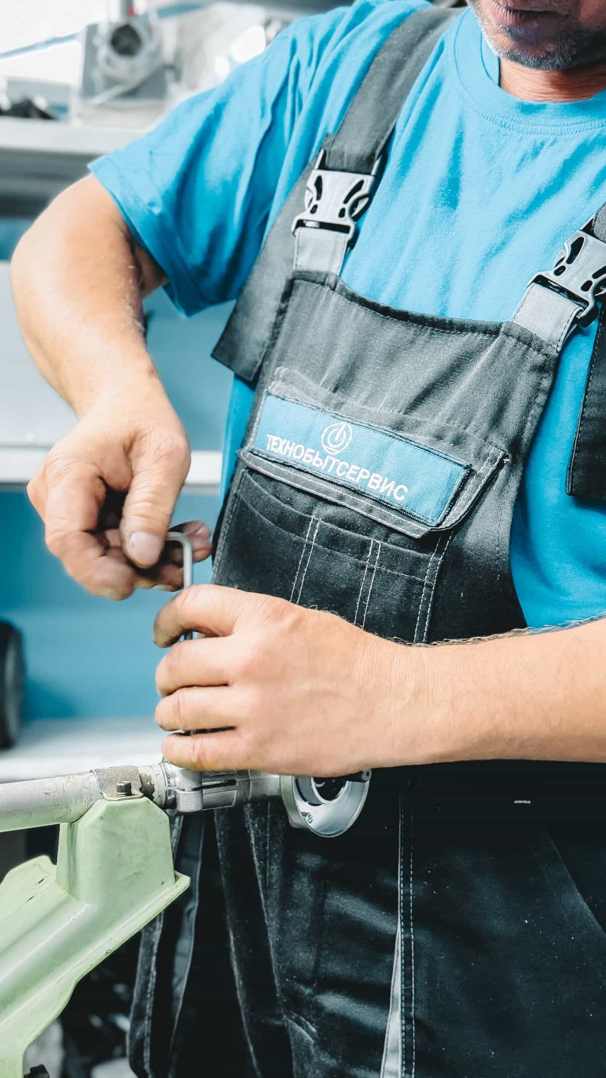 A technician shutting off and repairing a burst water supply line