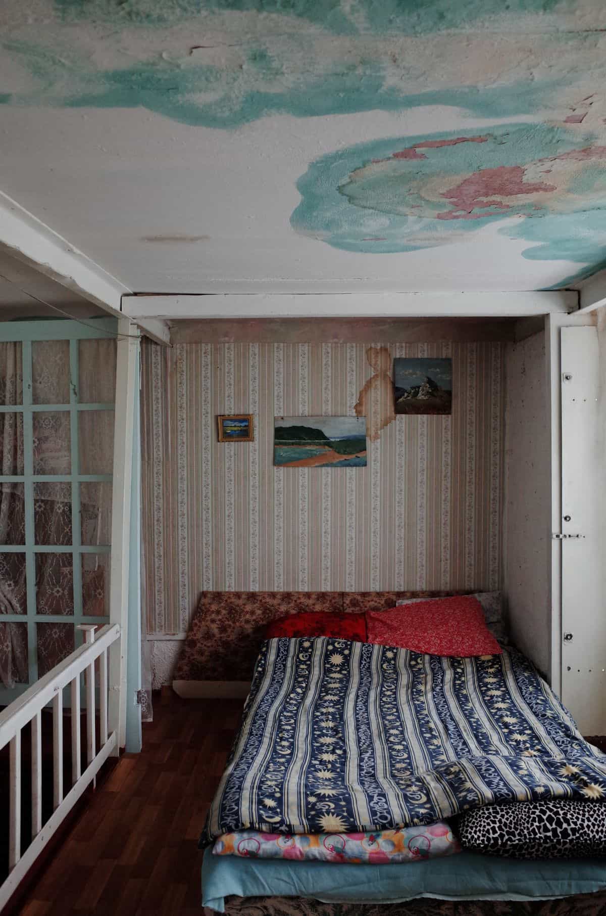 Brown water stains spreading across a ceiling from a leak