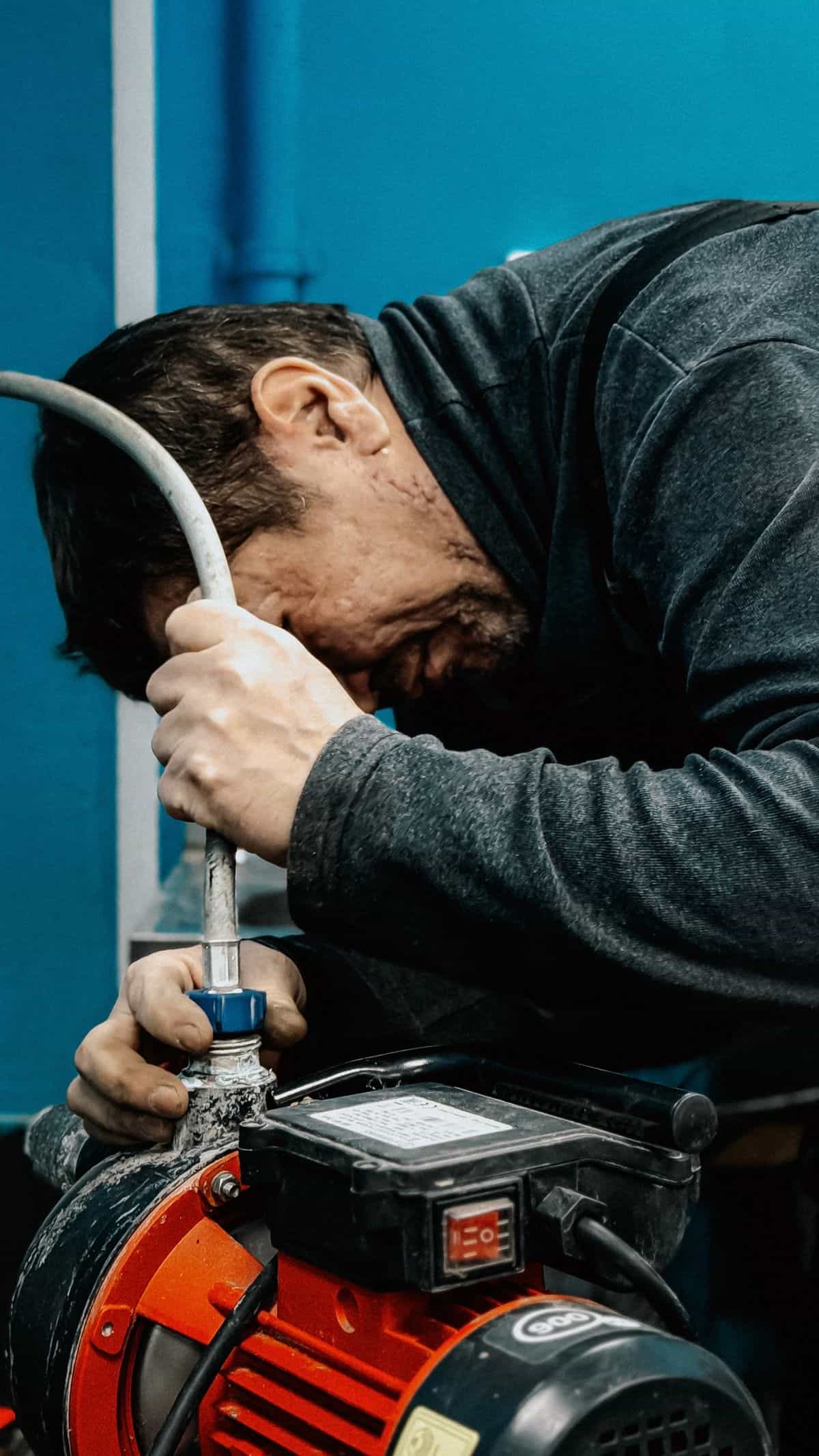 A technician operating water-removal equipment during a San Marcos water damage job