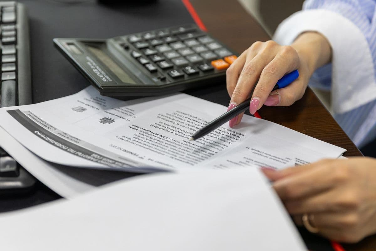 Reviewing water-damage scope and costs with paperwork at a desk