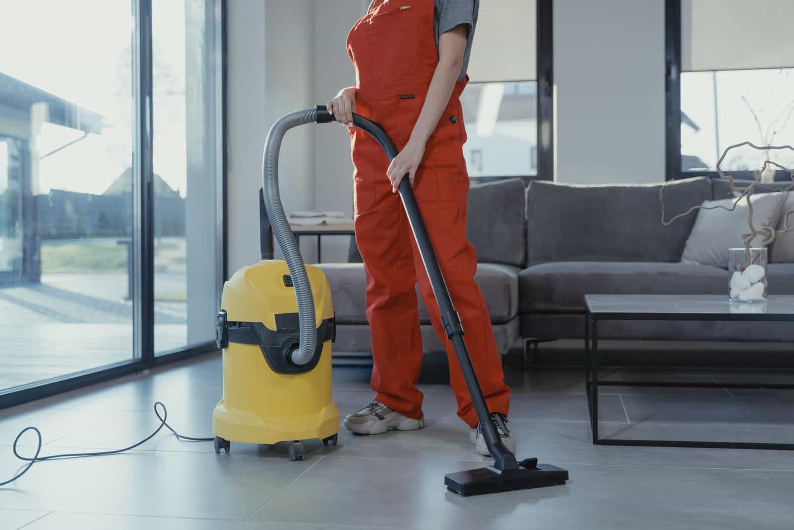 A uniformed restoration technician at work inside a San Marcos home