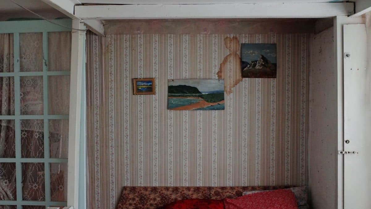 A damaged ceiling section cut out to expose dry joists before rebuild