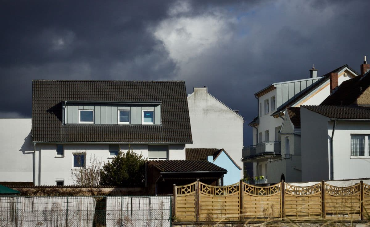 A tarp fastened over a storm-damaged section of roof on a Central Texas house